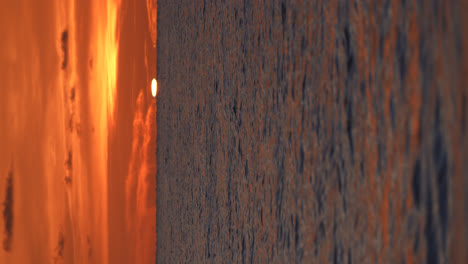 vertical shot of beautiful seaside sunset with golden sky, green flash phenomenon in naples florida