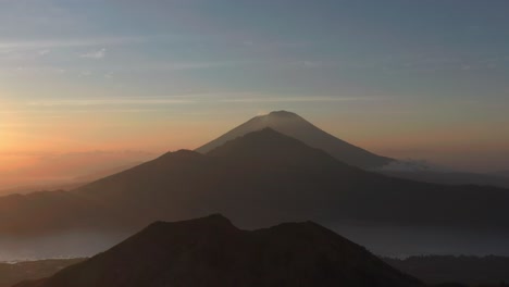 magical morning view of volcano silhouettes in bali, aerial