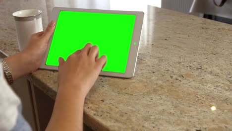 asian woman using tablet with green screen