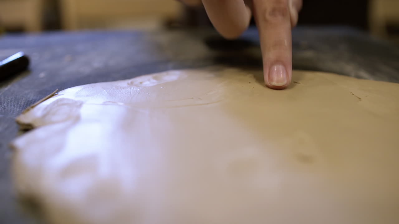 Person working with clay