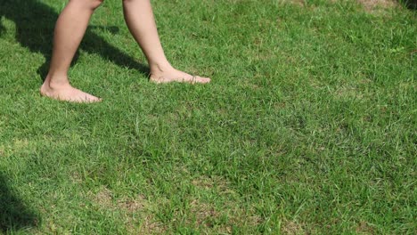 person walking barefoot on a lawn