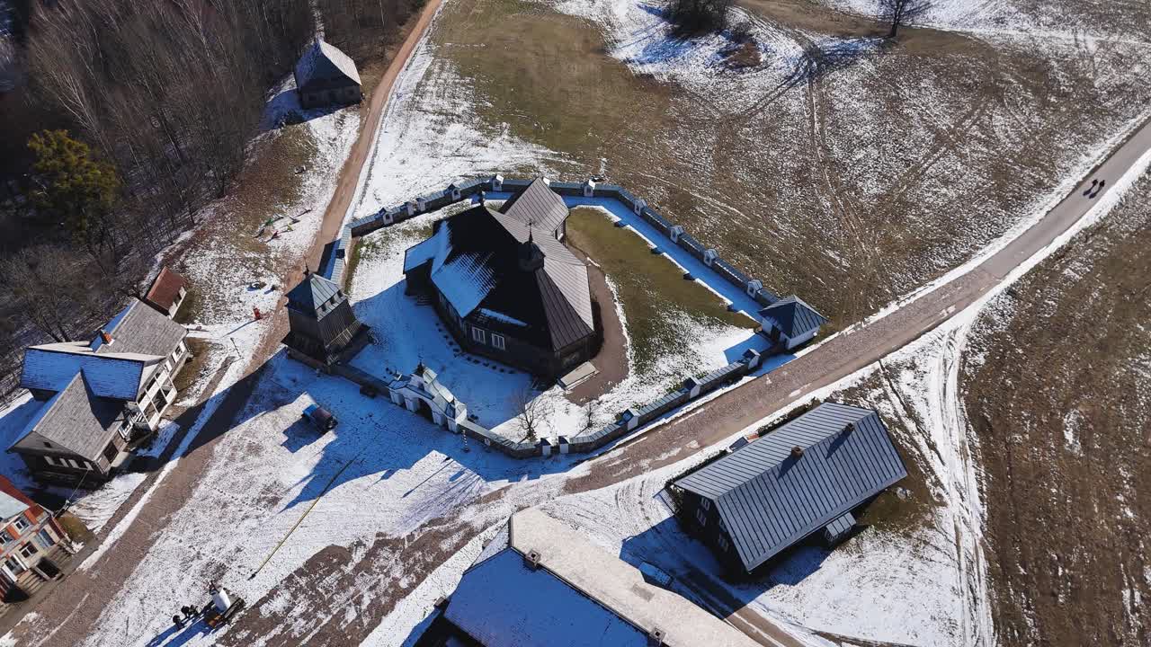 Old wooden church of Rumsiskes in Lithuania, aerial orbit view