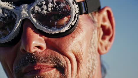 man with icy goggles