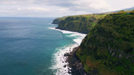 ocean surf splashing coastal woodland cliffs white foam slow motion. stormy sea