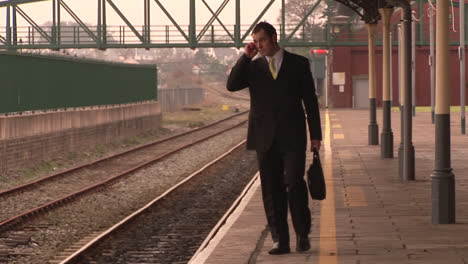 man waiting at a train station