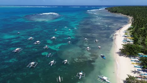 forward glide drone shot over fishing boats near a beach in siargao island, philippines