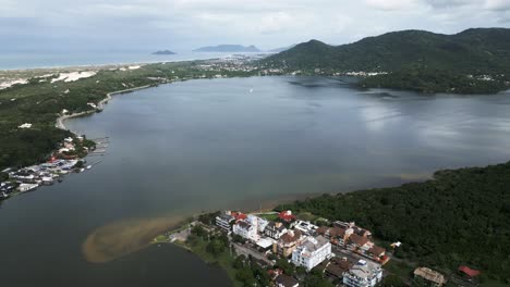 aerial drone fly above lagoa da conceicao, tourist town in santa catarina island florianopolis brazil, natural lagoon and mountains landscape