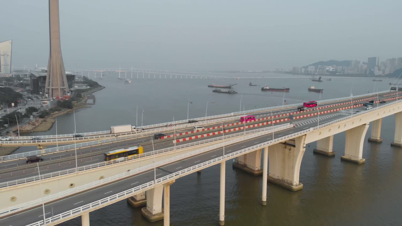 Aerial pan shot along Sai Van Bridge in Macau revealing Taipa skyline and Macau bay