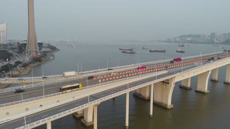 aerial pan shot along sai van bridge in macau revealing taipa skyline and macau bay