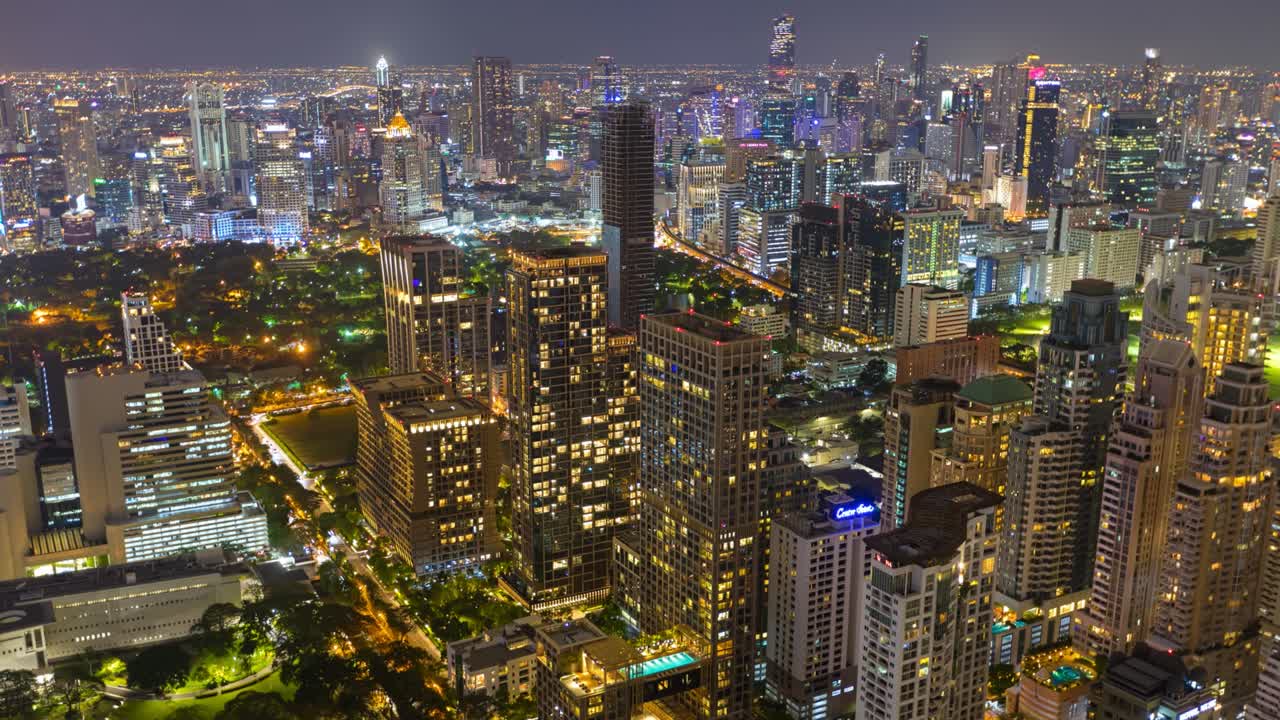Aerial view of Ploenchit junction with cars traffic skyscraper buildings. Bangkok City in downtown at night, Thailand