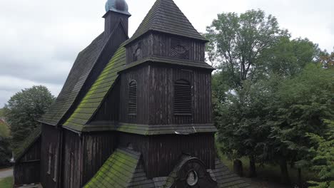 aerial dolly tilt to old medieval wooden catholic church