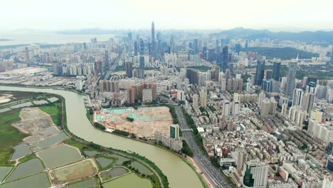 aerial view over shenzhen cityscape with massive urban development and skyscrapers