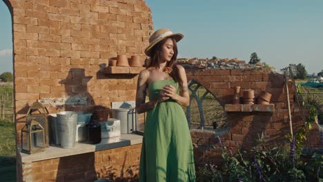 woman in a green dress in a rustic garden