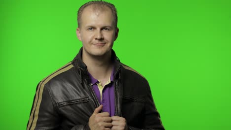 Rocker-man-saluting-with-hand-and-pretending-to-listen-order.-Guy-biker-on-chroma-key-background