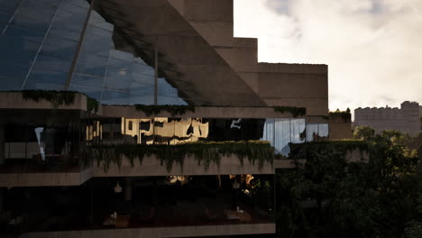 overgrown modern building at sunset