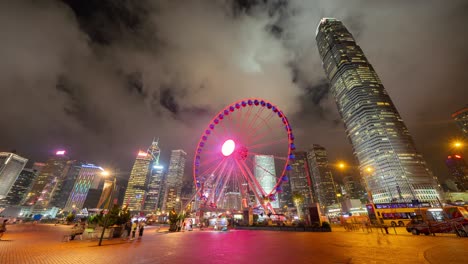 time lapse of the ferris wheel, hong kong observation wheel, and amusement park for kids in holiday vacation and travel trip concept. hong kong city. downtown and victoria harbour.