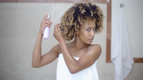 Woman-Using-Hair-Spray-In-Bathroom