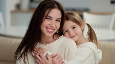 portrait of little cute girl bonding her mom for a picture