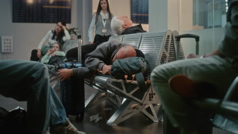 tired traveler sleeping at airport
