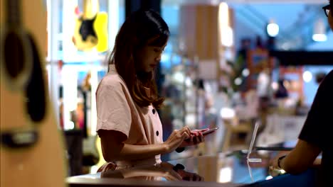 young woman paying by scanning qr code with smartphone