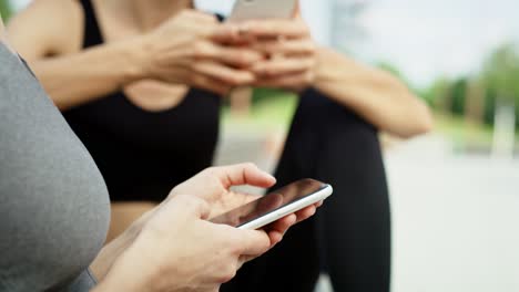 Close-up-video-of-two-woman-using-mobile-phone