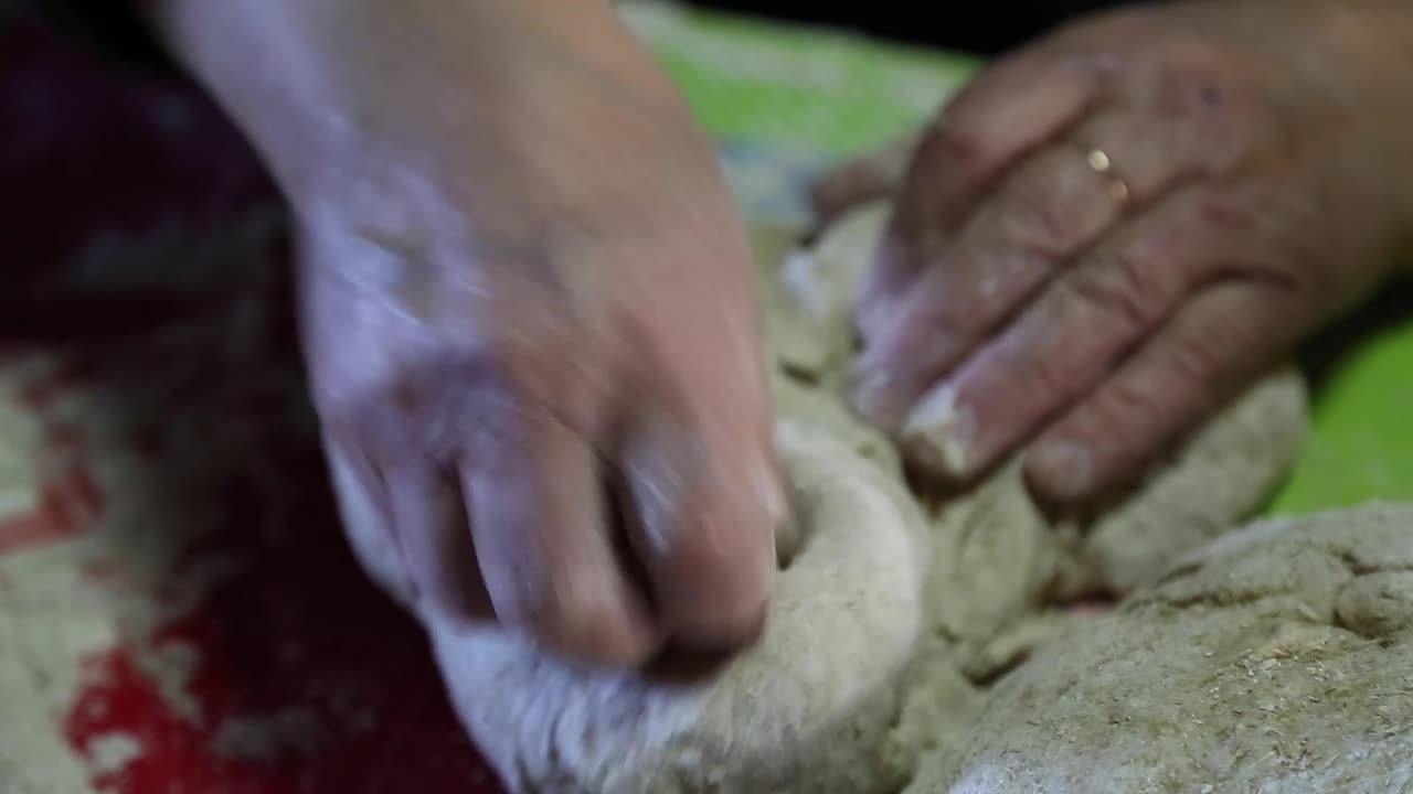 Woman kneading to make bread.