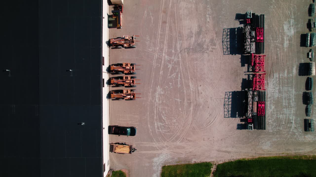 Top-down aerial view of construction and farming equipment in industrial yard in Green Bay, Wisconsim, USA