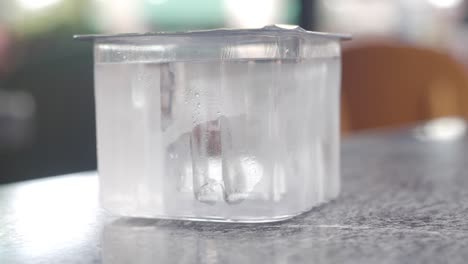 frozen water in a plastic container