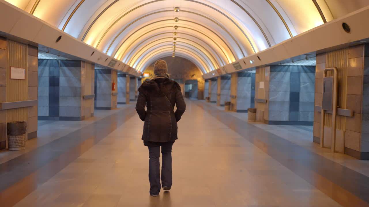 Woman walking in subway tunnel
