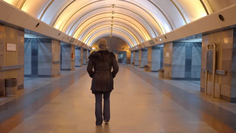 woman walking in subway tunnel