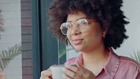black woman at window drink coffee
