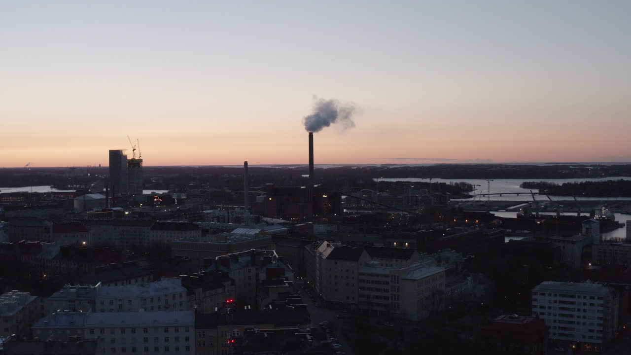 Aerial drone view of city and industrial chimney exhaust smoke