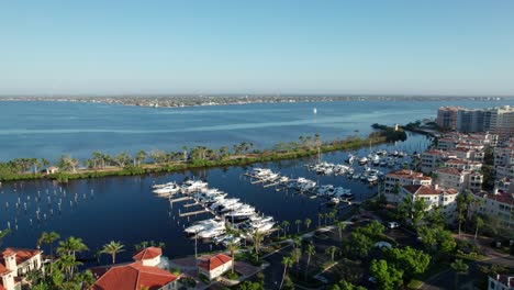 cinematic drone shot flying over a harbor full of boats in fort myers, florida