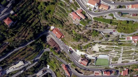 Italian-Amalfi-coastline-terraces-with-roads-in-the-town-of-San-Michele-seen-from-above,-Aerial-top-view-dolly-up