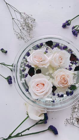 floating roses and flowers in a glass bowl