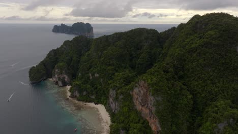 Drone-footage-from-PhiPhi-islands-in-Thailand-footage-of-incredible-Thai-landscapes-incredible-nature-with-insane-rocks,-beaches,-hills,-ocean-adn-boats