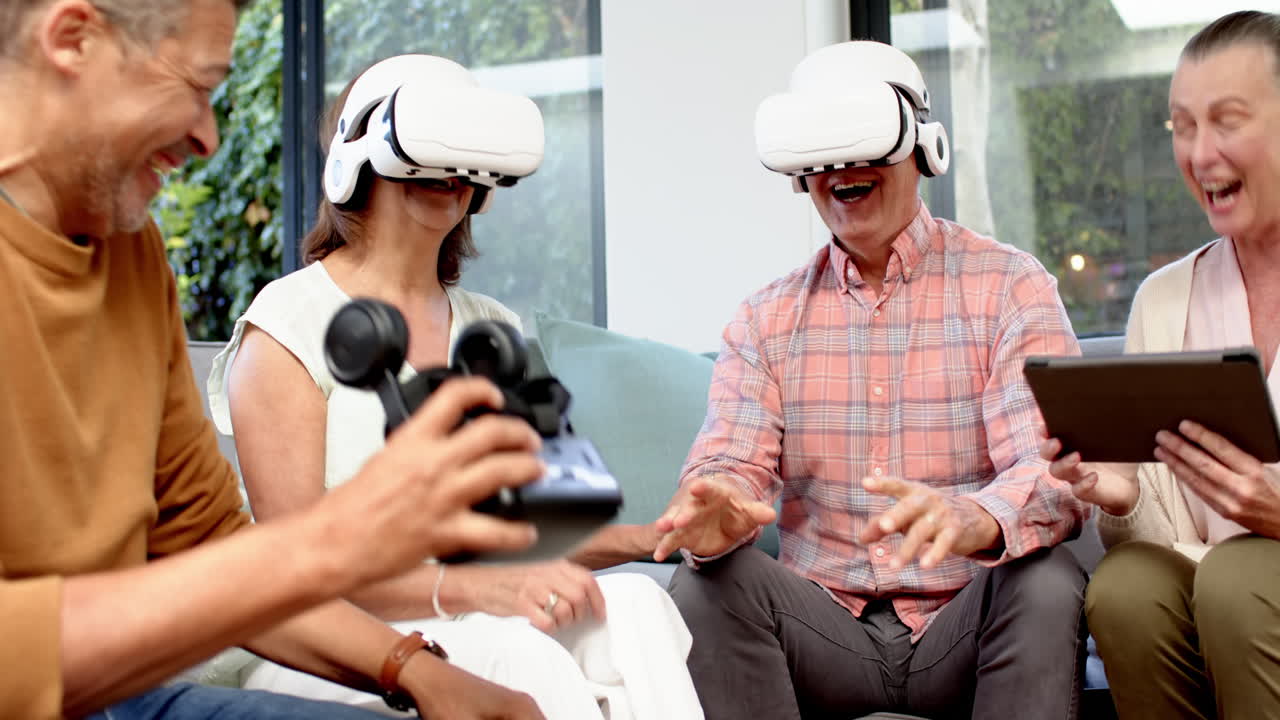 Wearing VR headsets, senior friends laughing and enjoying virtual reality experience