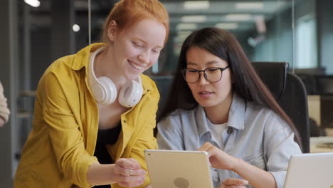 female office workers discussing project