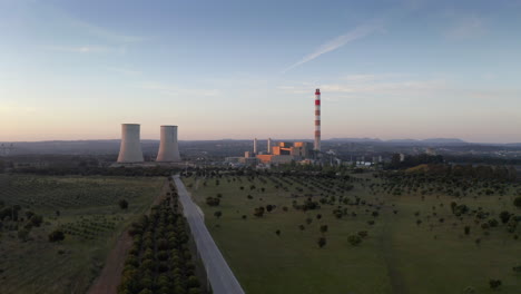 thermoelectric power plant shot at sunset with a beautiful blue sky