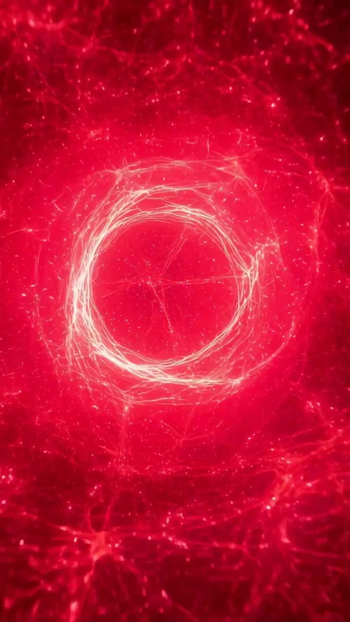 Video verticale: Scintilla che avvia la formazione di un anello di filamento centrale, pulsando e stabilizzandosi in una nebulosa rossa.