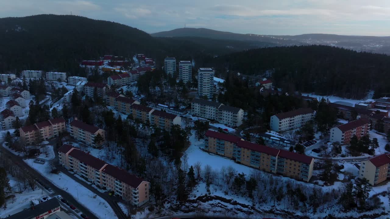 Tonsengagen Bjerke Arvoll Oslo Norge Norway aerial drone snowing snow flakes cold cloudy winter day gray skies city neighborhood apartment condo buildings landscape Arctic circle forward downward