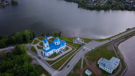 aerial view of a church by a lake