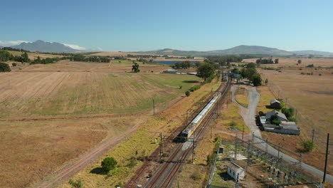 local train running through stellenbosch town, wine estate in western cape, south africa