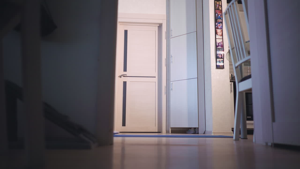 Woman Instructor Grounding Low Angle Meditation In Doorway, FloorLevel Perspective, Seated CrossLegged With Candles Nearby, Focused Breath And Teacher Energy Preparing Calm Session