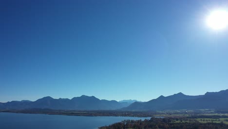 sunny sky over the alps of chiemsee lake in bavaria, germany