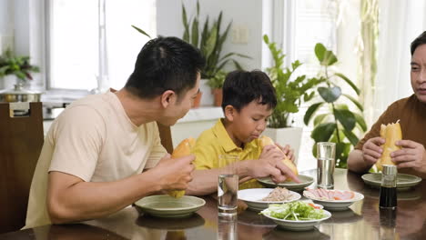 asian men and boy sitting at the table