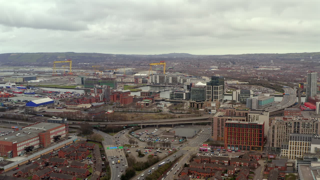 Aerial establishing view of Belfast city center buzzing with activity as St. Patrick's Day celebrations continue into the evening hours