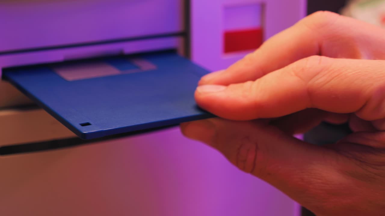 Using diskette for old computer. Music recorder, playing retro computer games. Vintage device for office, obsolete technology. . High quality 4k footage