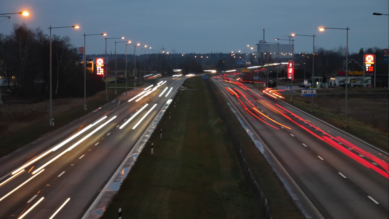 Aerial Timelapse of A1 Highway in Kaunas, evening, with Circle K gas station signs in front. Traffic concept.