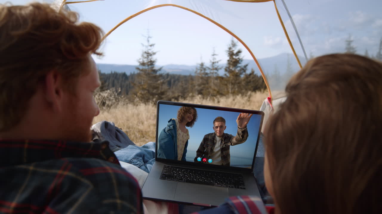 Travel friends talking online in virtual meeting closeup. Joyful couple waving